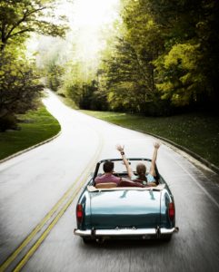 Couple taking a road trip in vintage car.